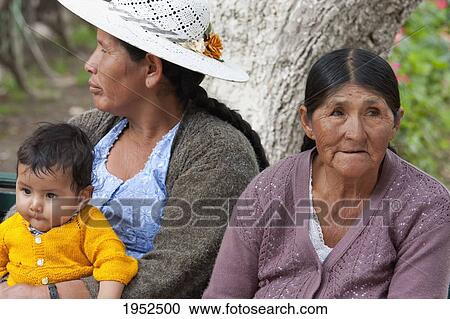 Stock Image - People sitting on a bench in Plaza 14 de Septiembre, Cochabamba, Bolivia. Fotosearch