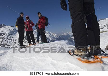 Stock Image - People Snowshoeing At Grimsel Pass, Goms Valley, Southwest Switzerland. Fotosearch