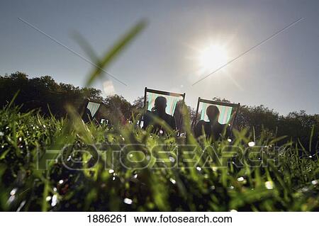 Stock Image - People Sunbathing In Green Park. Fotosearch