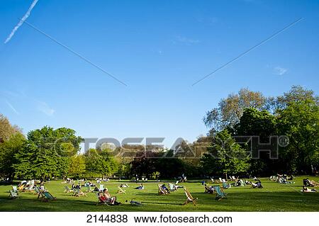 Stock Photo - People Sunbathing On A Spring Day In Green Park, Central London, London, Uk. Fotosearch