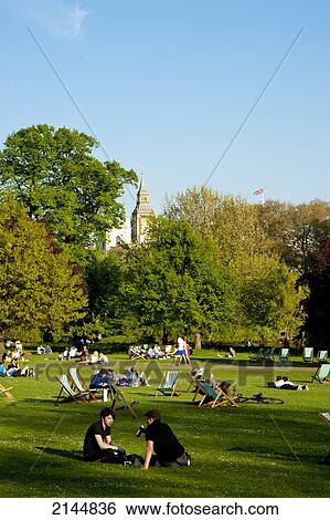 Stock Photograph - People Sunbathing On A Spring Day In Green Park, Central London, London, Uk. Fotosearch