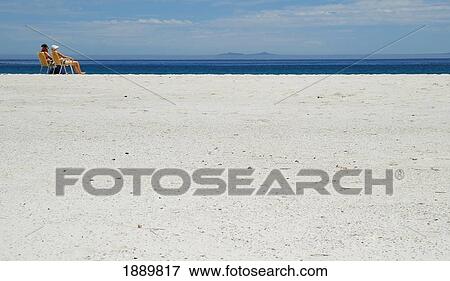 Stock Photo - People Sunbathing On Beach. Fotosearch