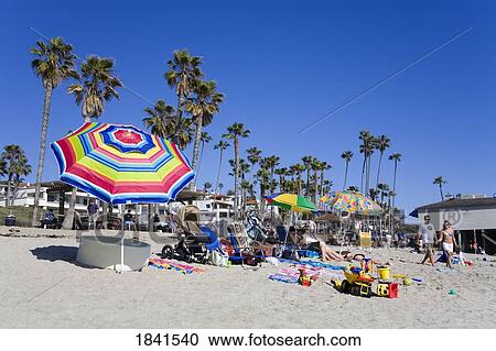 Stock Image - People Sunbathing On San Clemente Beach; San Clemente, Orange County, California, Usa. Fotosearch