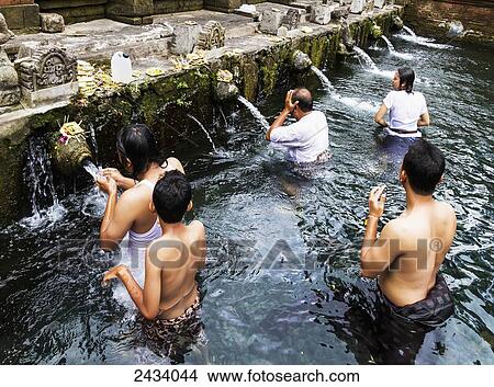 People taking a bath in the ritual purifying pool of Tiirta Empul Temple, part of the Subak landscape of Pakerisan Watershed, Tampaksiring, Bali, Indonesia View Large Photo Image Picture - People taking a bath in the ritual purifying pool of Tiirta Empul Temple, part of the Subak landscape of Pakerisan Watershed, Tampaksiring, Bali, Indonesia. Fotosearch