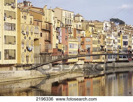 Stock Photograph - People Walking Across Bridge Over The Riu Onyar, Girona, Catalunya, Spain.. Fotosearch