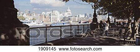 Stock Photography - People Walking Along The Thames Path Near The South Bank Centre Towards St Pauls Cathedral And The City, London, Uk.. Fotosearch