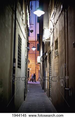 People Walking Down A Street As Viewed Through The Buildings; Genoa Liguria Italy View Large Photo Image Stock Photography - People Walking Down A Street As Viewed Through The Buildings; Genoa Liguria Italy. Fotosearch