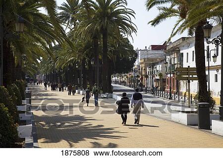 People Walking Down The Promenade; El Puerto De Santa Maria, Andalusia, Spain View Large Photo Image Stock Photo - People Walking Down The Promenade; El Puerto De Santa Maria, Andalusia, Spain. Fotosearch