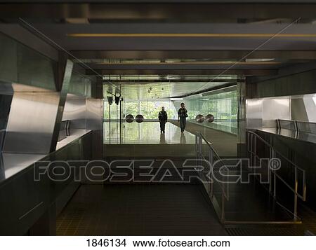 Picture - People Walking Inside Modern Building; Hong Kong, China. Fotosearch