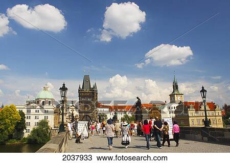 Stock Image - People Walking On Charles Bridge Or Karluv Most; Prague Czech Republic. Fotosearch