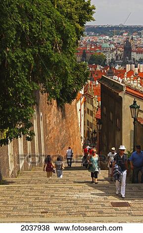 Stock Photo - People Walking On The Steps Leading Down To The Old Town From The Royal Palace On Castle Hill; Prague Czech Republic. Fotosearch