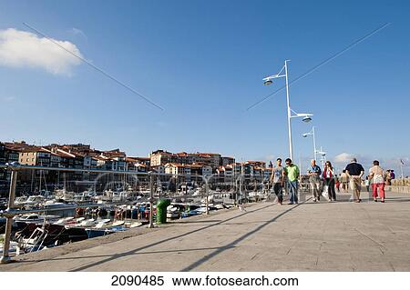 People Walking On Walkway At Lekeitio Harbor, Basque Country, Spain View Large Photo Image Stock Photography - People Walking On Walkway At Lekeitio Harbor, Basque Country, Spain. Fotosearch