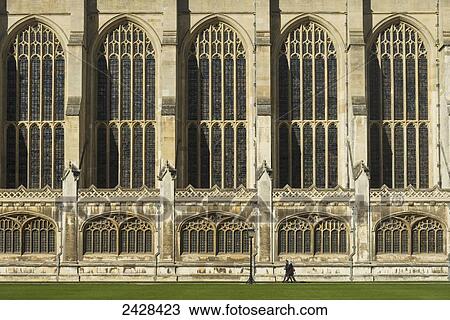 Stock Image - People walking past Kings College Chapel; Cambridge, Cambridgeshire, England. Fotosearch