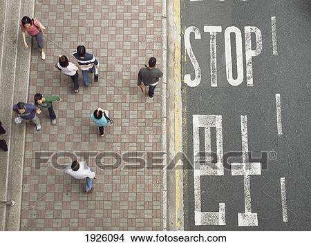 Picture - People Walking Past 'stop' Sign. Fotosearch
