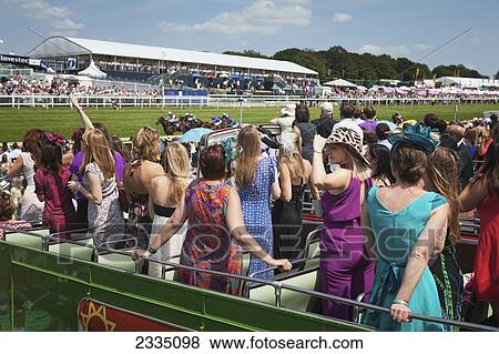 Stock Photo - People Watching Horseracing From Open Top Bus At Epsom Derby; London, England, Uk. Fotosearch