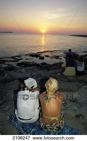 Stock Photo - People Watching The Sunset At Cafe Del Mar, Ibiza, The Balearic Islands, Spain.. Fotosearch