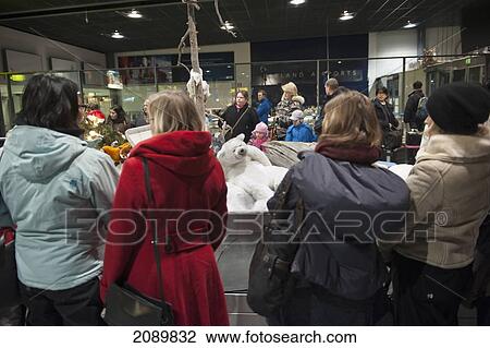 Stock Image - People With Christmas Decorations In Baggage Hall At Rovaniemi Airport, Levi, Lapland, Finland. Fotosearch