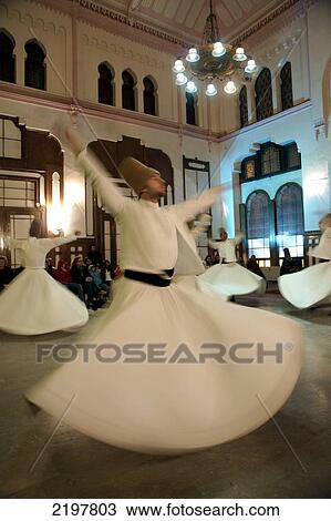Stock Image - Performance By Whirling Dervishes Of The Galata Mevlevi Lodge At Sirkeci Station Waiting Room, Sultanahmet, Istanbul, Turkey. (C) Marc Jackson/Axiom. Fotosearch