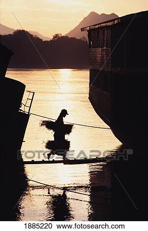Person Crossing Cargo Boats On The Mekong River View Large Photo Image Stock Image - Person Crossing Cargo Boats On The Mekong River. Fotosearch