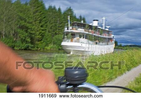 Person Cycling Along Gota Canal, Sweden View Large Photo Image Stock Photo - Person Cycling Along Gota Canal, Sweden. Fotosearch