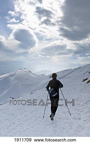 Stock Photo - Person Hiking In Aletsch Plateau, Rear View, Eggishorn, Switzerland. Fotosearch