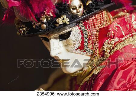 Stock Photograph - Person in Venetian costume during Venice carnival; Venice, Italy. Fotosearch