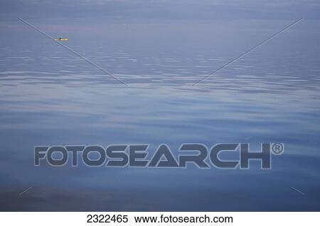Stock Photography - Person kayaking on calm waters; Washington State, USA. Fotosearch