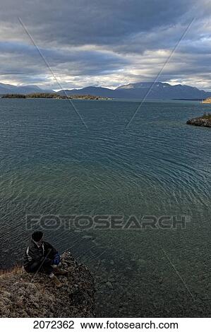 Person Looking Over Atlin Lake In Atlin Provincial Park, British Columbia, Canada View Large Photo Image Stock Image - Person Looking Over Atlin Lake In Atlin Provincial Park, British Columbia, Canada. Fotosearch