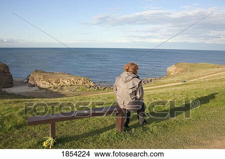 Person Sitting On Bench, South Shields, Tyne And Wear, England View Large Photo Image Picture - Person Sitting On Bench, South Shields, Tyne And Wear, England. Fotosearch