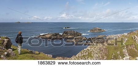 Stock Photo - Person Standing, Island Of Iona, Scotland; Island Of Iona, Scotland. Fotosearch