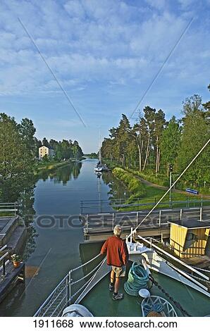 Person Standing On Boat's Bow On Gota Canal Cruise, Sweden View Large Photo Image Stock Photo - Person Standing On Boat's Bow On Gota Canal Cruise, Sweden. Fotosearch