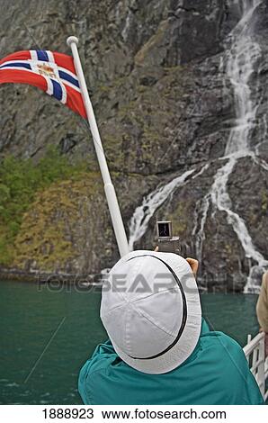 Stock Image - Person Videoing Waterfall. Fotosearch
