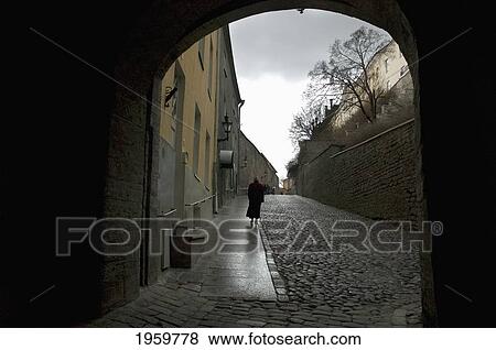 Person Walking At Long Leg Street In Tallinn, Estonia View Large Photo Image Stock Photo - Person Walking At Long Leg Street In Tallinn, Estonia. Fotosearch