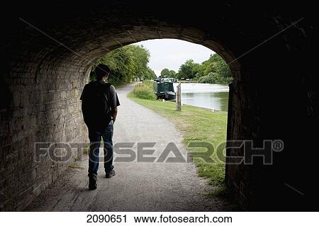 Person Walking In Tunnel At Kennet And Avon Canal In Caen Hill, Near Devizes, Wiltshire, Uk View Large Photo Image Stock Image - Person Walking In Tunnel At Kennet And Avon Canal In Caen Hill, Near Devizes, Wiltshire, Uk. Fotosearch