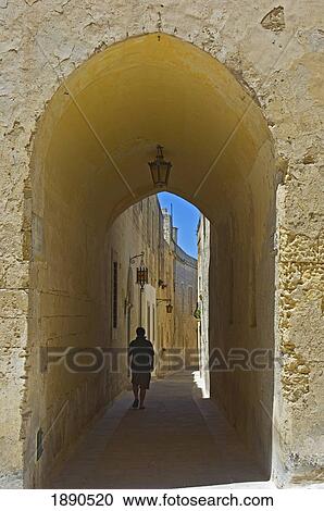 Person Walking Through Arched Passage View Large Photo Image Stock Image - Person Walking Through Arched Passage. Fotosearch