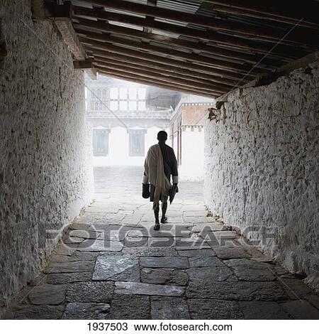 Person Walking Through Tunnel At Trongsa Dzong; Trongsa District Bhutan View Large Photo Image Stock Image - Person Walking Through Tunnel At Trongsa Dzong; Trongsa District Bhutan. Fotosearch