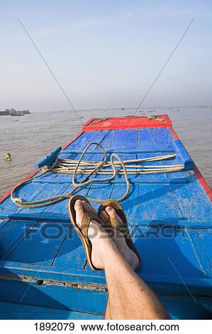 Stock Photo - Persons Feet On Boat In Mekong Delta, Low Section. Fotosearch