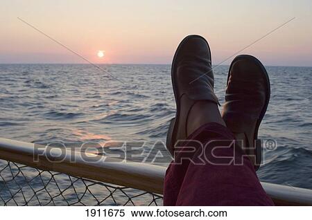 Person's Feet On Railing By Lake At Sunset, Lake Vanern, Sweden View Large Photo Image Stock Photography - Person's Feet On Railing By Lake At Sunset, Lake Vanern, Sweden. Fotosearch