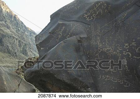 Picture - Petroglyphs On A Boulder Show A Large Of Number Of Sogdian And Brahmi Inscriptions, Along With A Phallus And A Swastika, Shatial Near Chilas, Northern Areas, Pakistan. Fotosearch