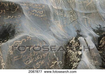 Stock Photo - Petroglyphs On A Boulder Show Sogdian And Brahmi Inscriptions, Shatial Near Chilas, Northern Areas, Pakistan. Fotosearch