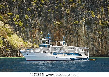 Stock Photography - Philippines, Cuyo Archipelago, Quiminatin Island, Dive Boat Cruising In Blue Ocean Water.. Fotosearch