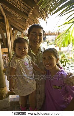 Stock Image - Philippino Family At Holiday Resort; Puerto Gallera, Mindoro Island, Philippines. Fotosearch