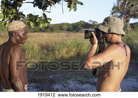 Photographer Taking Photo Of Man On Beach, Tanzania View Large Photo Image Stock Image - Photographer Taking Photo Of Man On Beach, Tanzania. Fotosearch