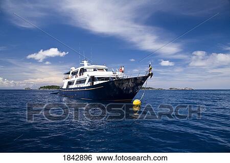 Stock Photograph - Phuket, Thailand; Ship Offshore In The Similan Islands National Marine Park. Fotosearch