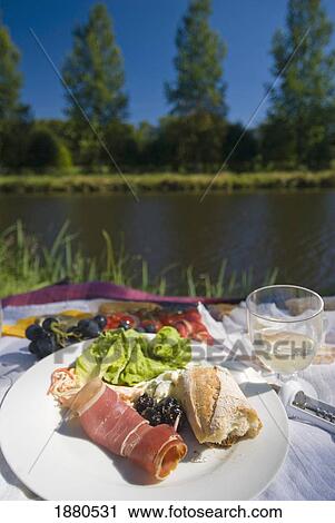 Stock Image - Picnic On The Banks Of The Nantes Brest Canal, Low Angle View. Fotosearch