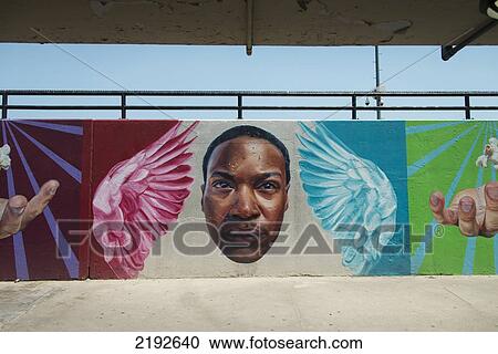 Stock Image - Picture Of A Face Hands And Angels On Colourful Murals On A Wall; Chicago Illinois United States Of America. Fotosearch