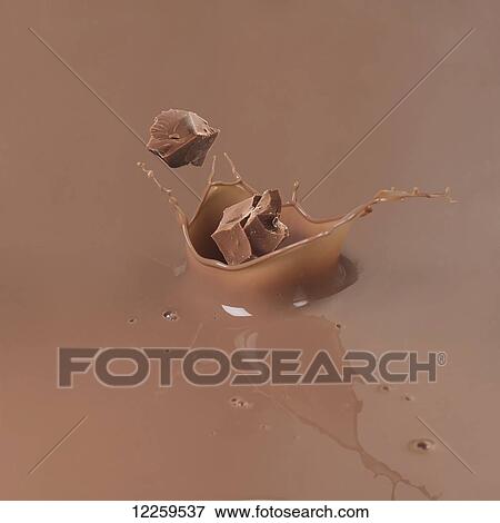 Pieces of chocolate splashing into melted chocolate View Large Photo Image Stock Photo - Pieces of chocolate splashing into melted chocolate. Fotosearch