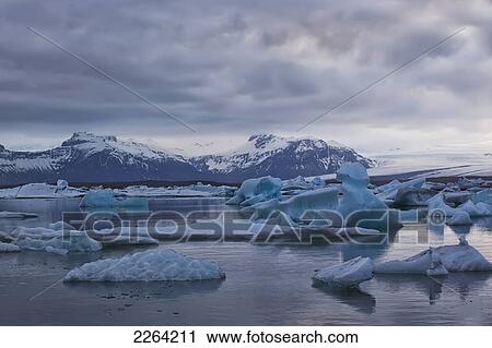Stock Image - Pieces of ice calves floating in glacial lagoon jokulsarlon; iceland. Fotosearch