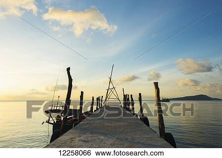 Stock Photograph - Pier at sunset off Tui Beach, Koh Rong Island; Sihanoukville, Cambodia. Fotosearch
