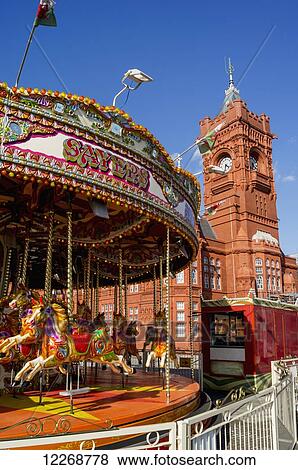 Stock Photo - Pierhead Building and carousel in the foreground; Cardiff, Wales. Fotosearch